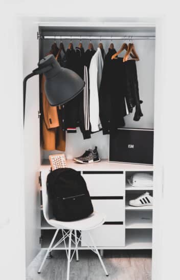 black backpack on white chair beside cabinet
