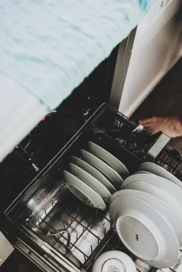 white ceramic plate on black dishwasher