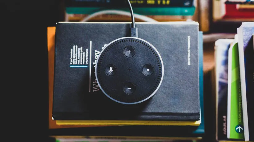 black Amazon Echo on black covered book