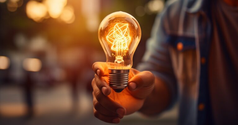 An Image Of A Person Holding A Lightbulb